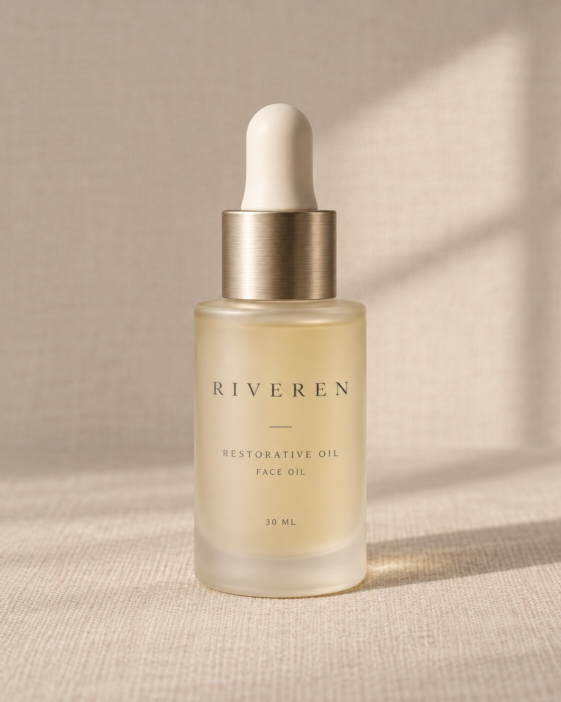 Riveren Restorative Oil in its frosted glass bottle